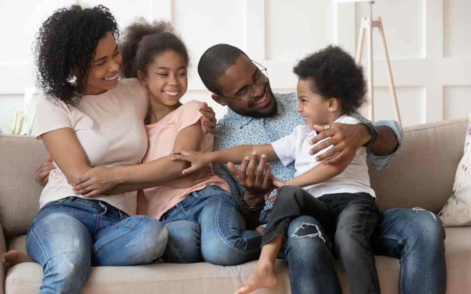 Happy family on couch image